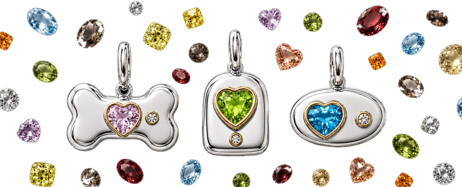 Three BooBoos charms surrounded by the nine loose gemstones
