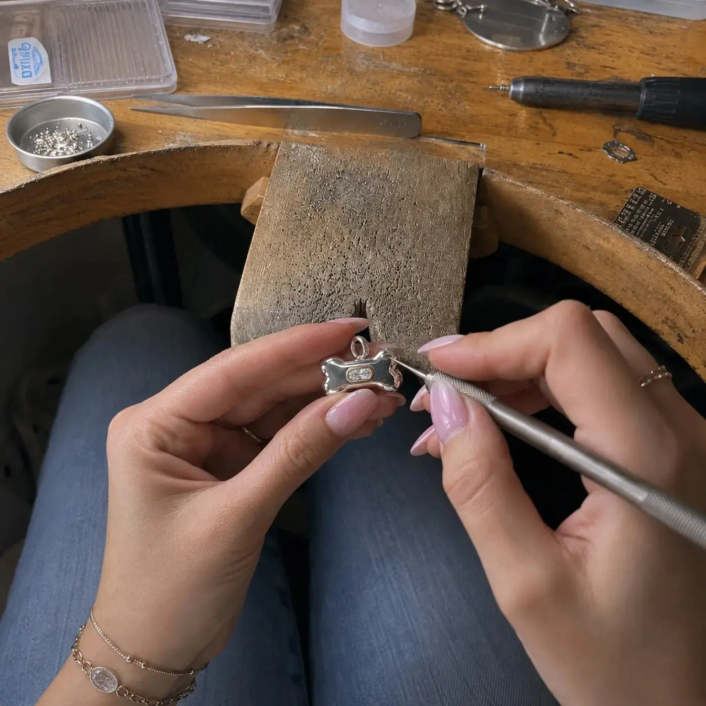 A BooBoos charm being finished at the Bangkok jewelry bench