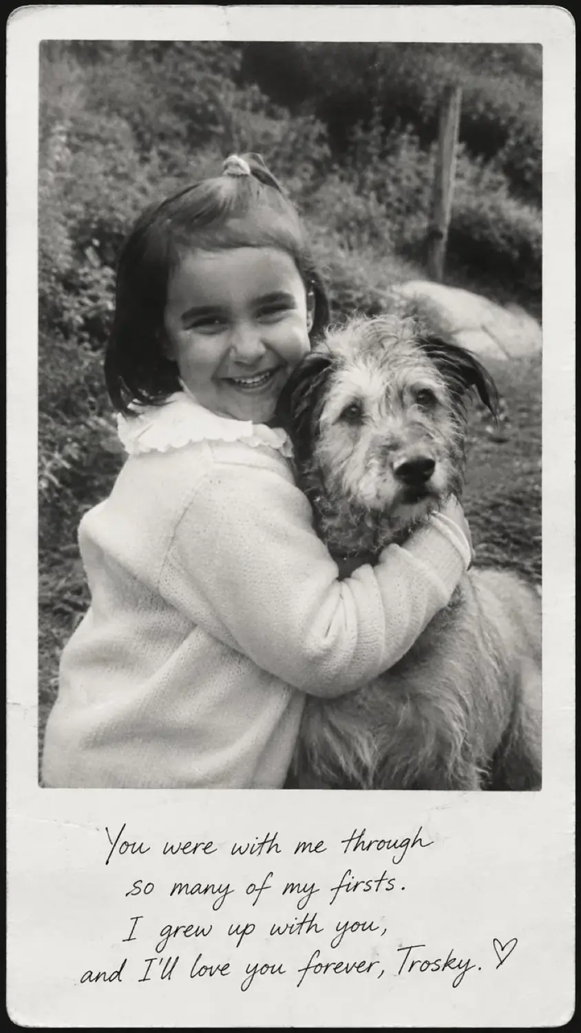 Childhood photo of Maria hugging Trosky, her family dog, with the original handwritten note