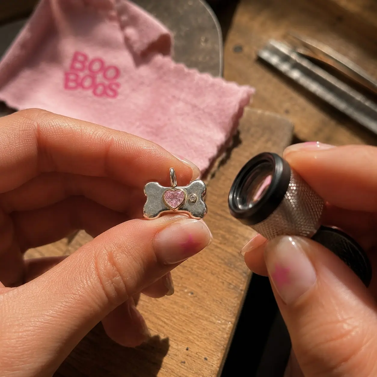 A finished charm checked under the loupe